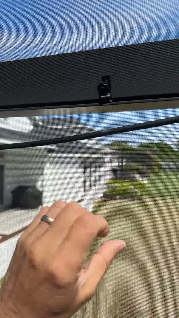 Anchor clip seated in channel with screw hole visible