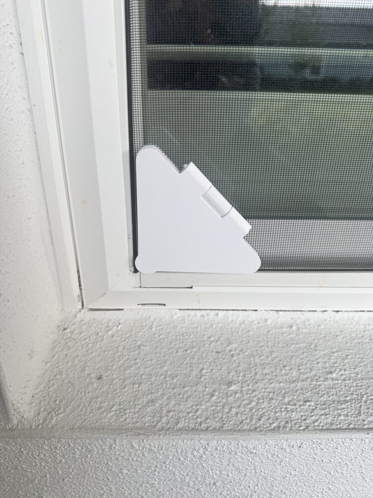 Screen Pass-Thru closed and low-profile in the corner of a window screen